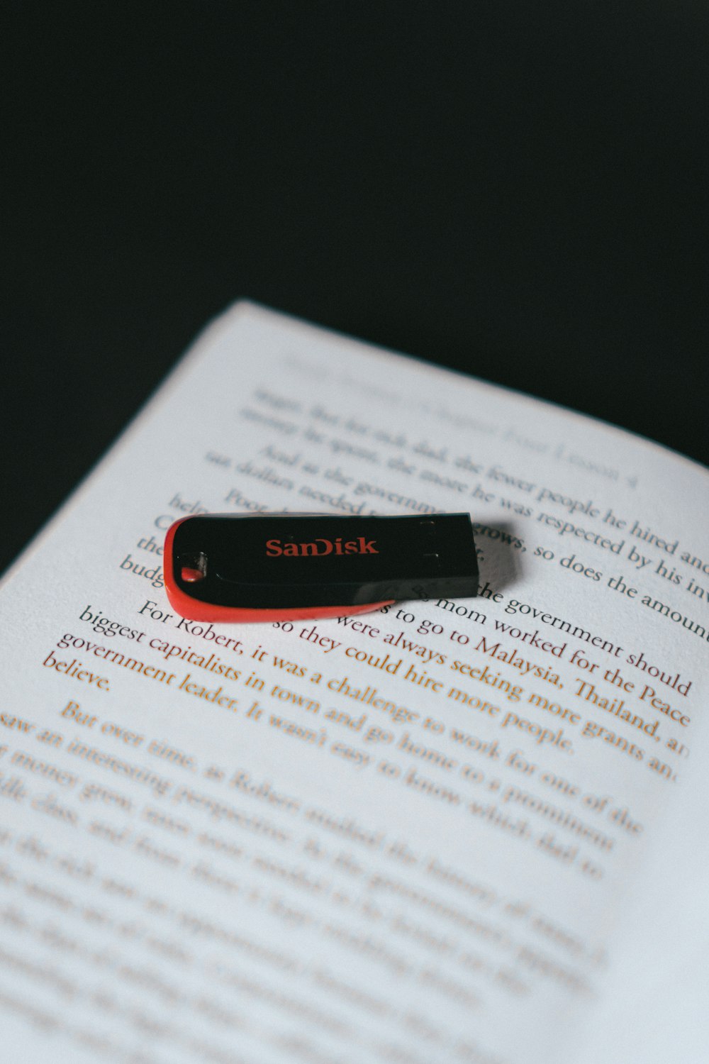 red and black flash drive on white printer paper