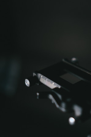 Close-up of a finely calibrated micrometer resting on a steel workbench.
