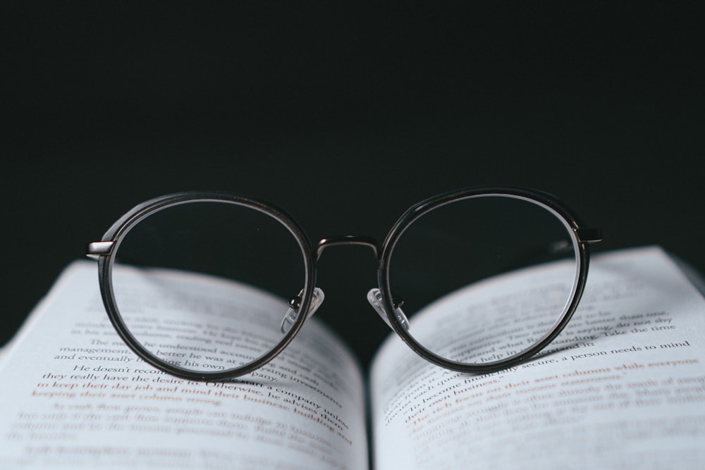 silver framed eyeglasses on book page