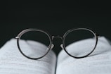 silver framed eyeglasses on book page