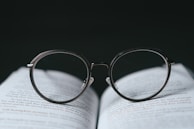 silver framed eyeglasses on book page