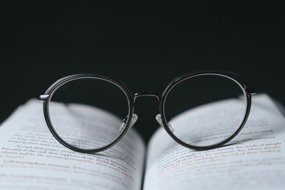 silver framed eyeglasses on book page