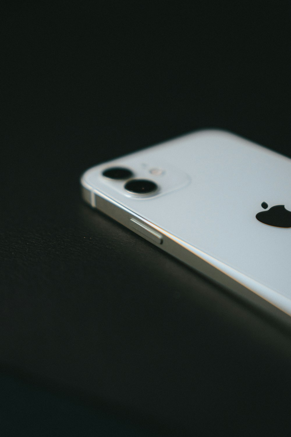 silver iphone 6 on black table