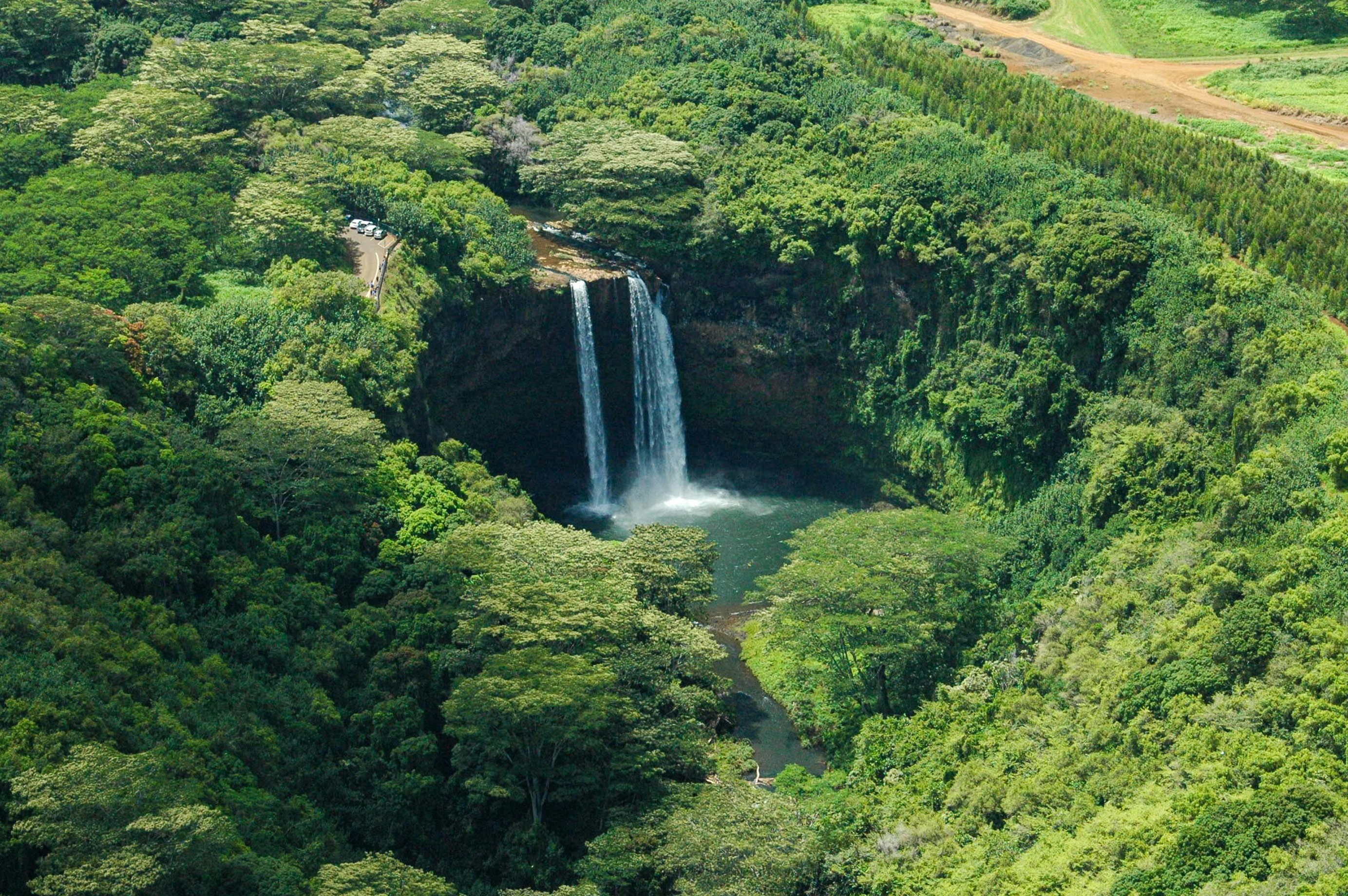 waterfalls in the middle of green trees, Wailua waterfall view from a helicopter on the island of Kauai.