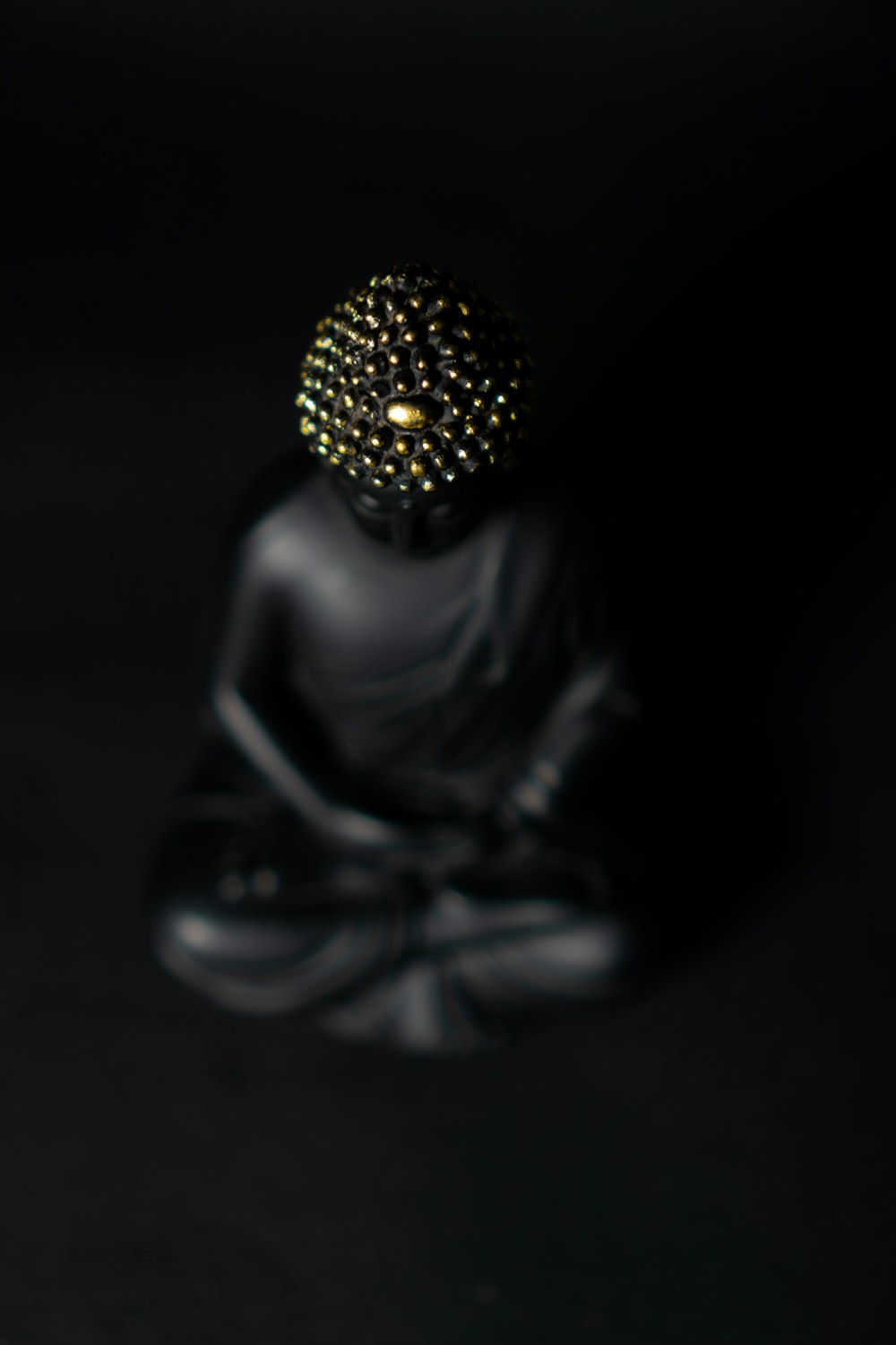 black and gold buddha figurine