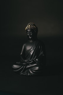 black and gold buddha figurine