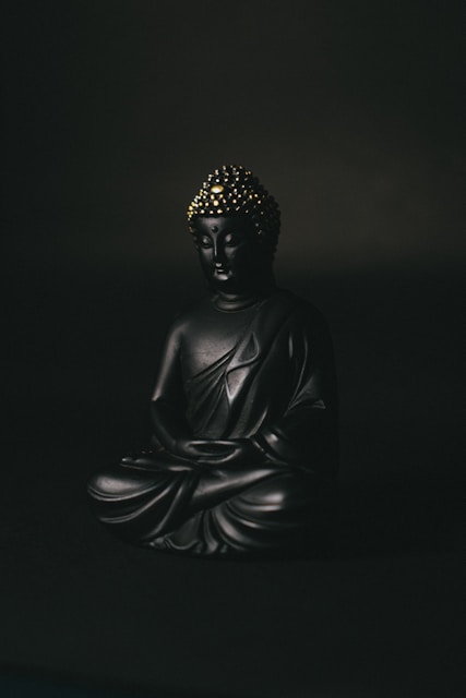 A serene figure meditating surrounded by golden dark energy and cosmic symbols.