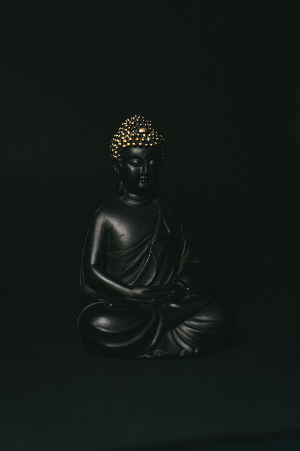 black and gold buddha figurine