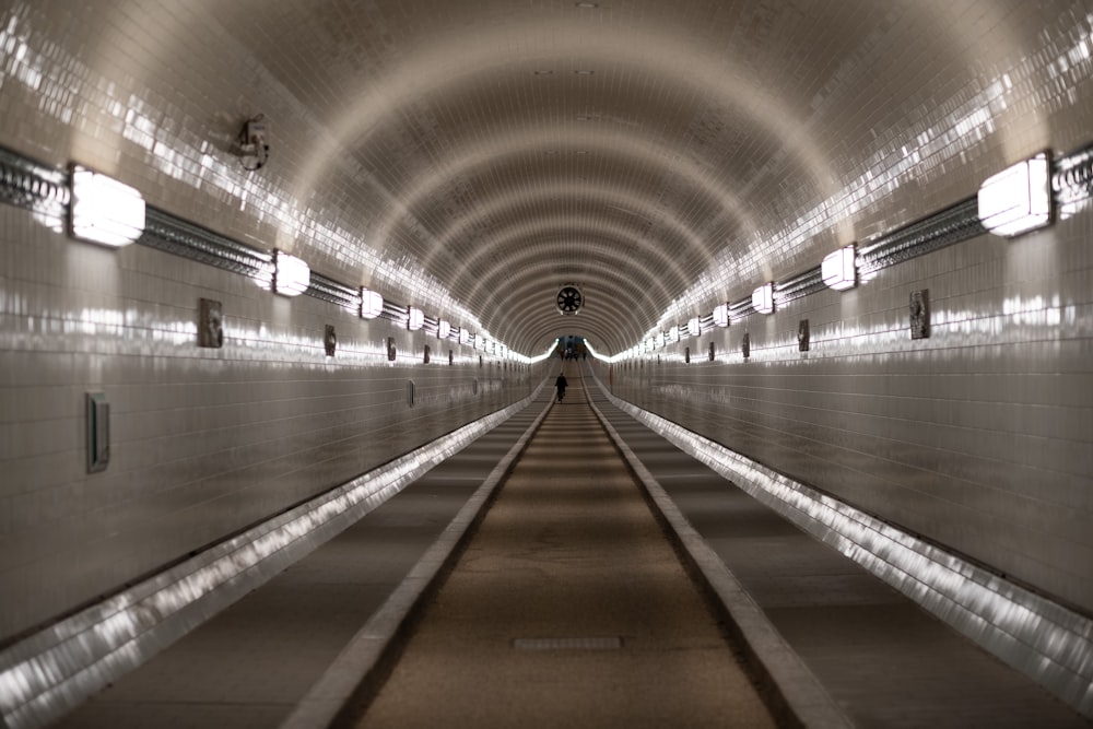 people walking on hallway with lights turned on during night time