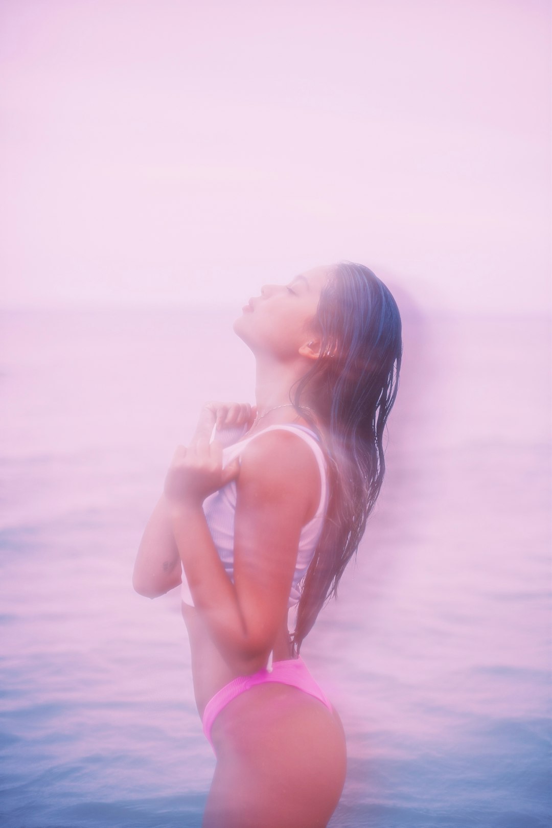 woman in pink bikini bottom standing on beach during daytime