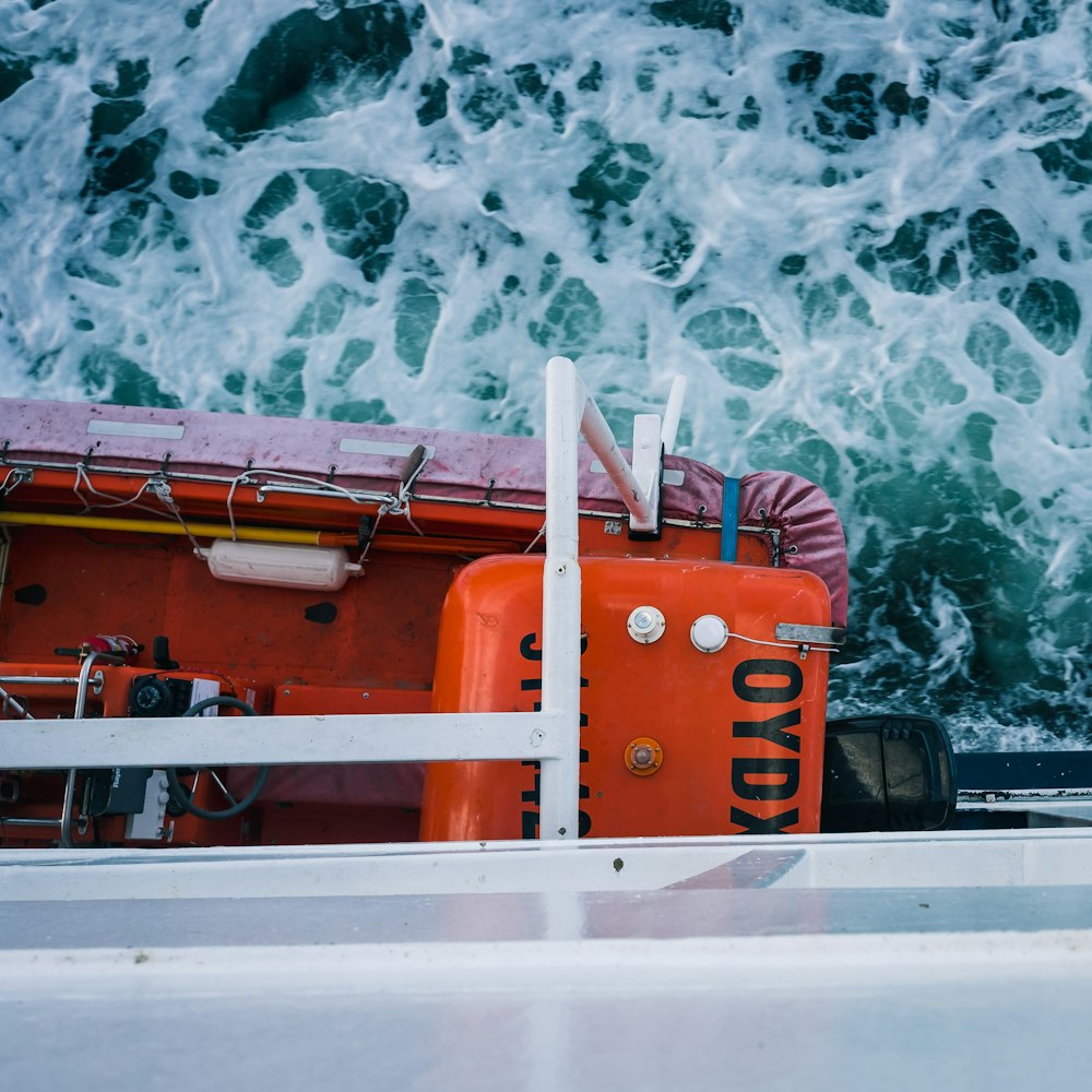 orange and black boat on water