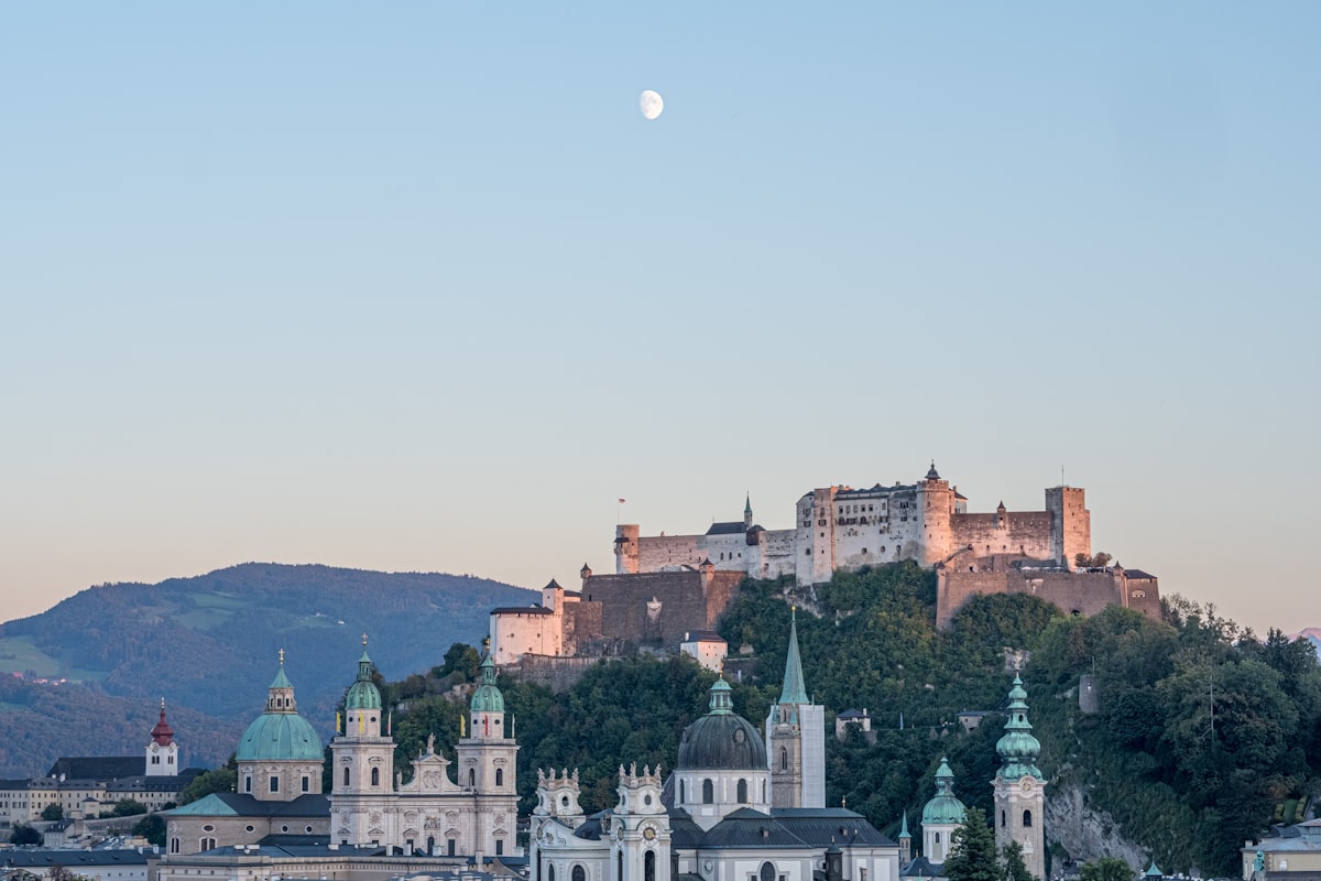 December Salzburg Christmas market lights on Residenzplatz with snowy Cathedral