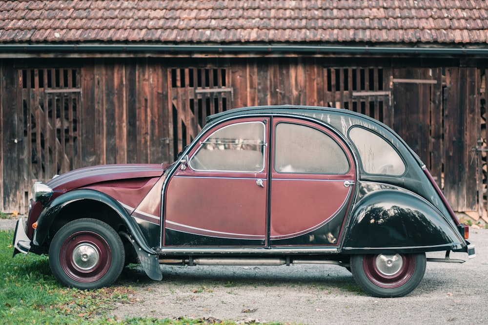 black and brown vintage car parked beside brown brick wall