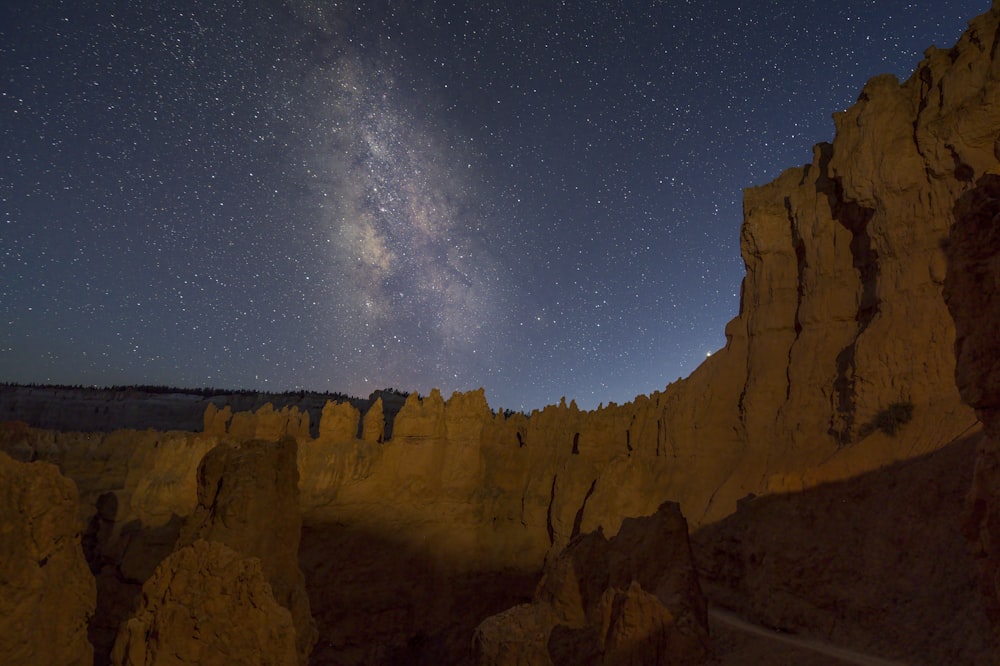 brown rock formation under blue sky during night time