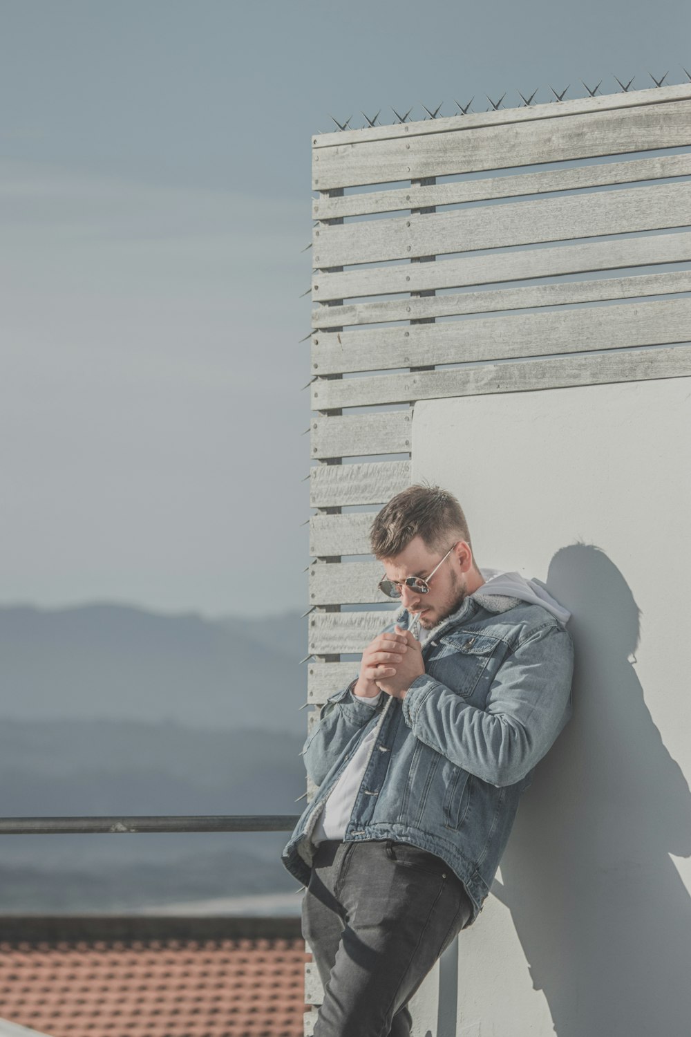 man in gray jacket smoking cigarette