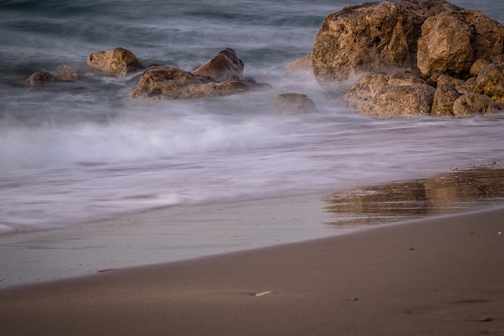 brown rock formation on sea shore during daytime