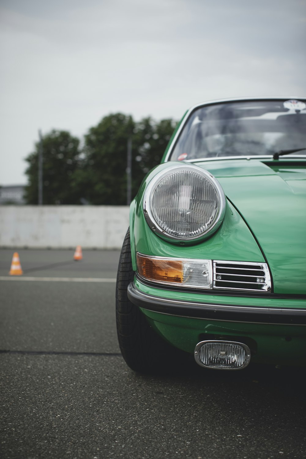 green car on the road during daytime