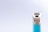 A close-up of a lighter featuring a metallic ignition wheel and a turquoise body against a light gray background.