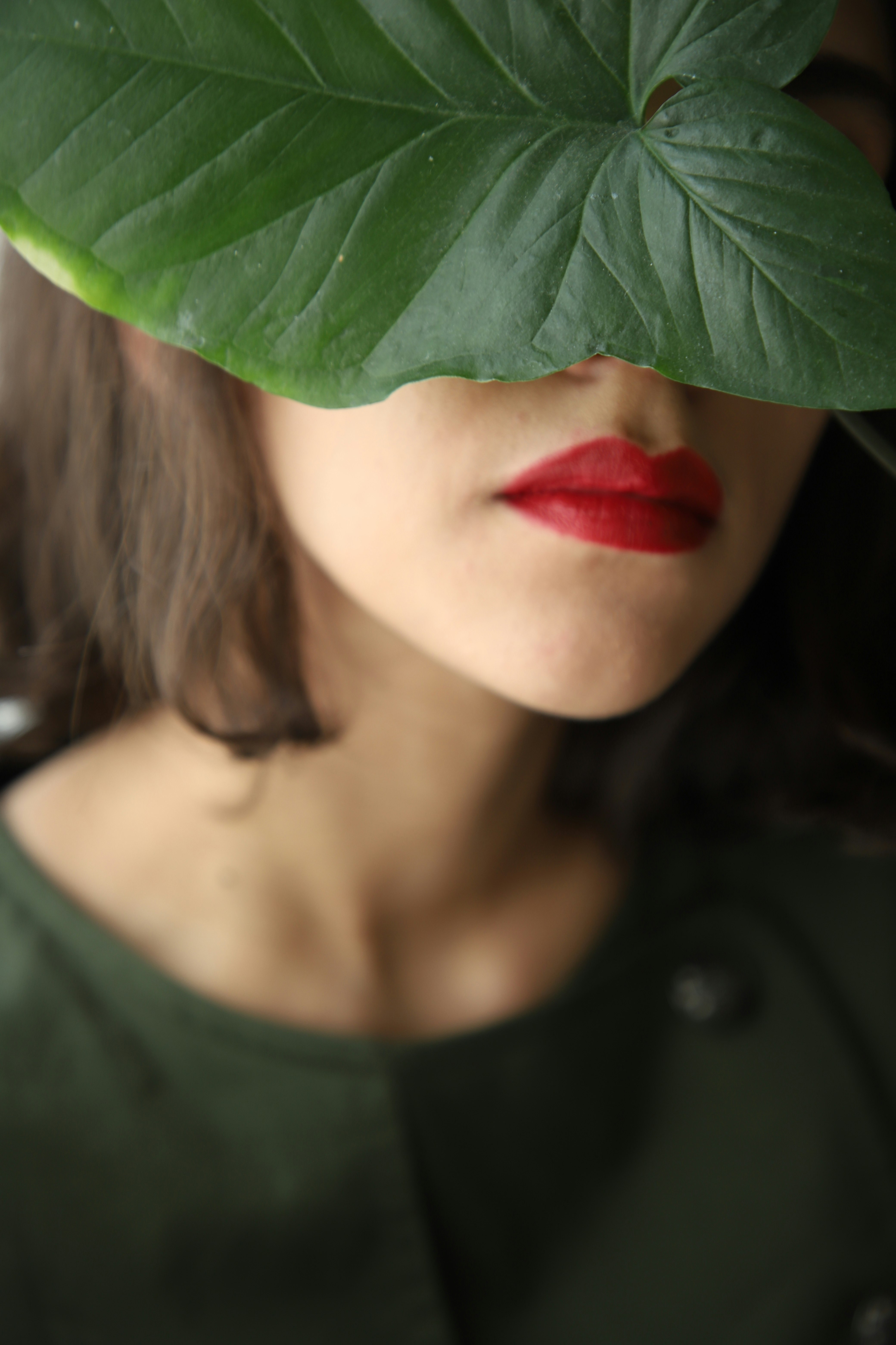 woman in black scoop neck shirt with red lipstick