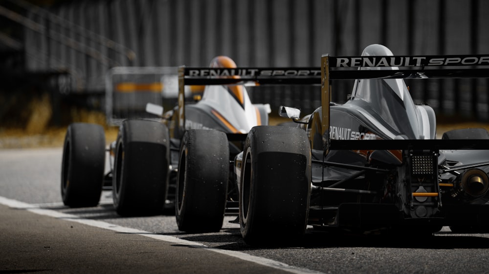 black and yellow f 1 car on road during daytime