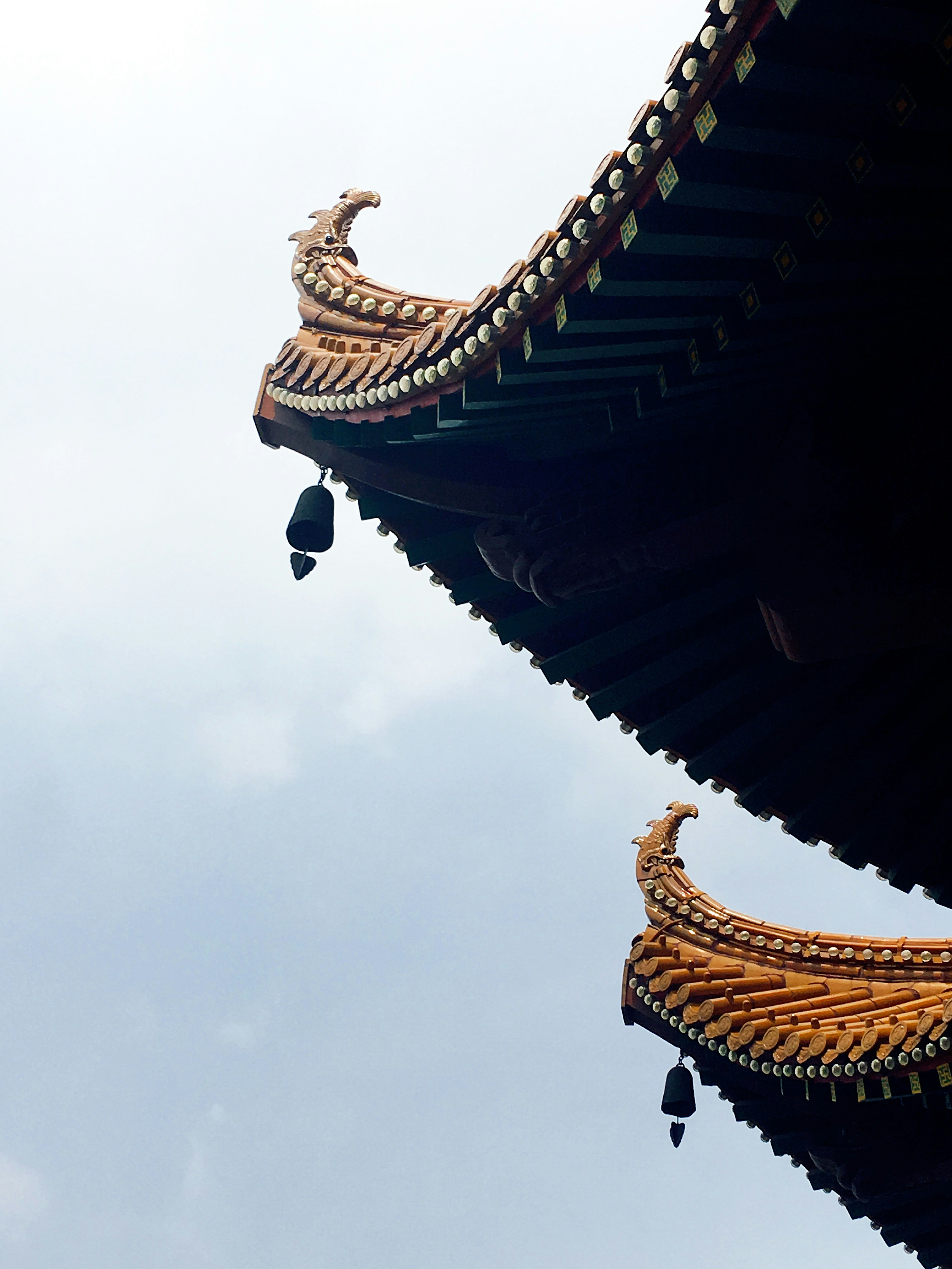 gold dragon statue under cloudy sky during daytime