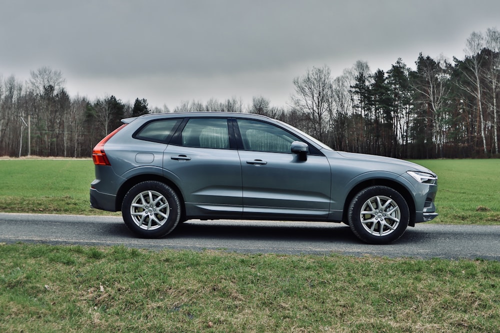 gray suv on green grass field during daytime