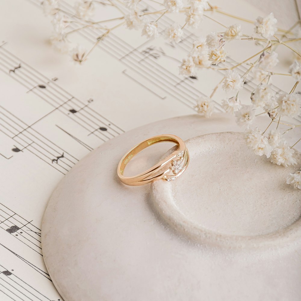 gold ring on white textile