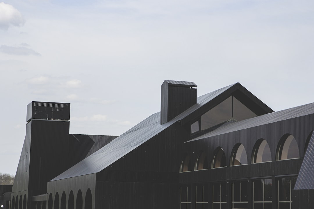 white and black wooden house under white sky during daytime