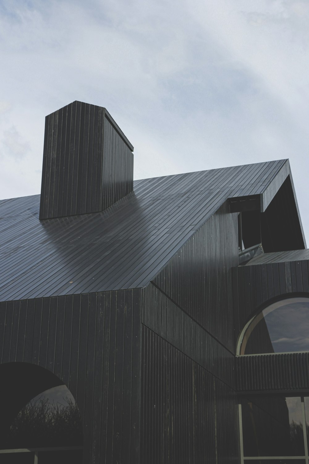 black wooden house under white clouds during daytime