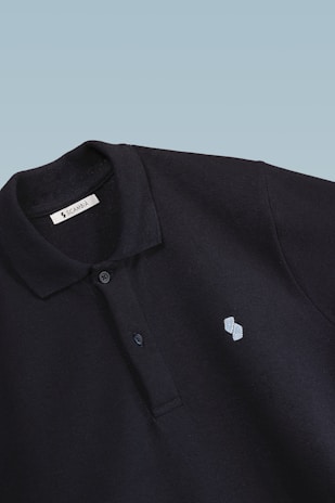 Close-up of a premium marell polo shirt collar with fine stitching and embroidered logo on a crisp white background.