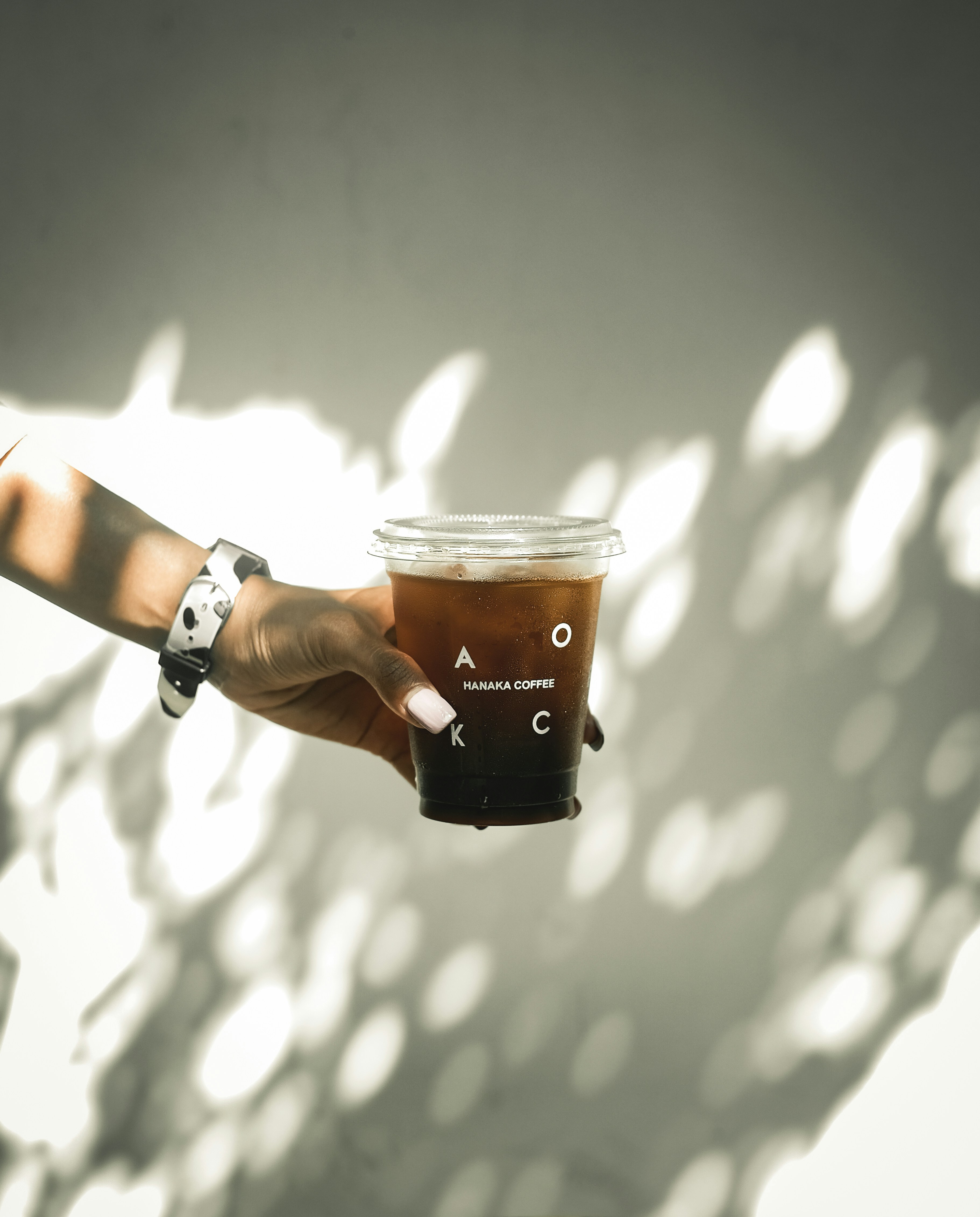 person holding black and white cup