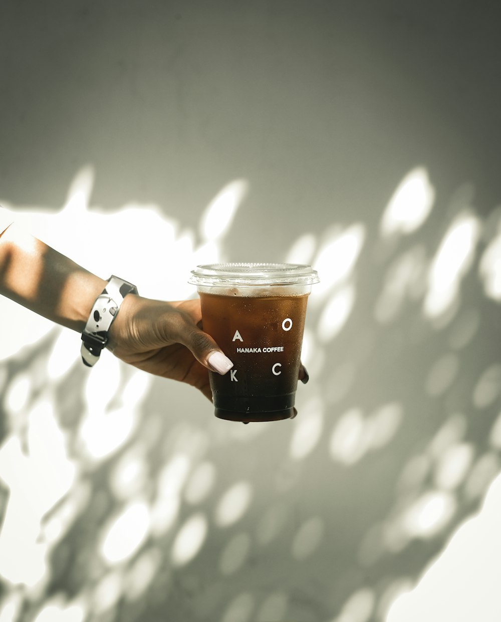 person holding black and white cup