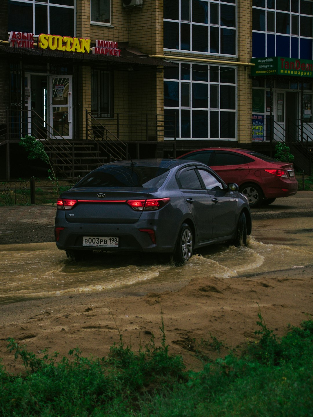 black sedan parked near brown building