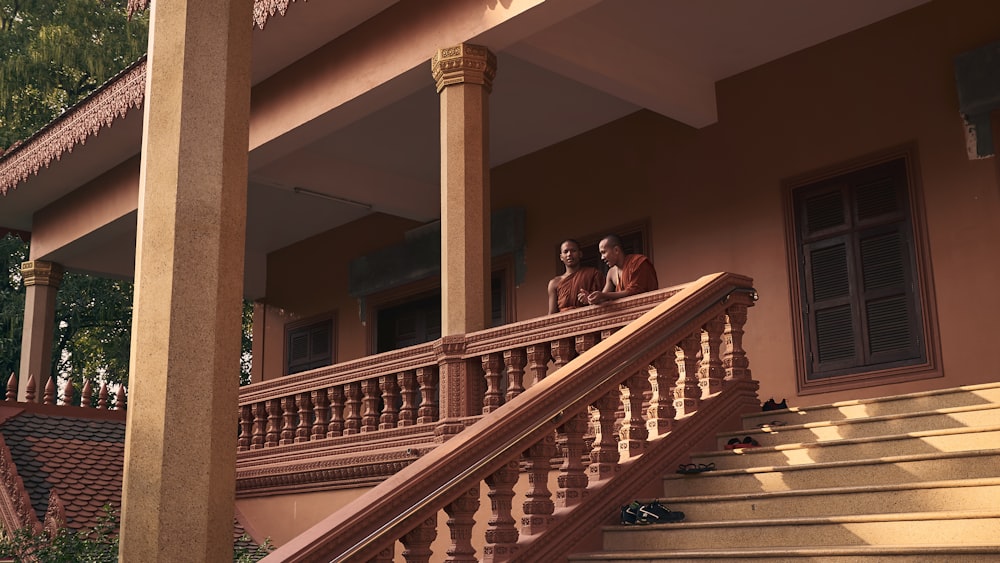 woman in black jacket sitting on brown wooden staircase