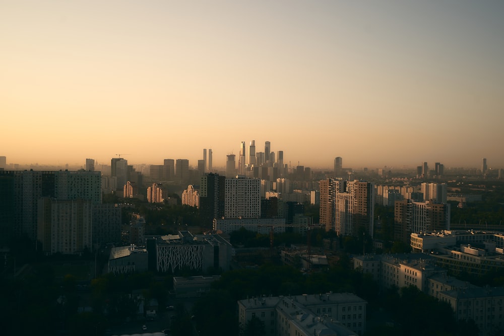 city skyline under orange sky during sunset