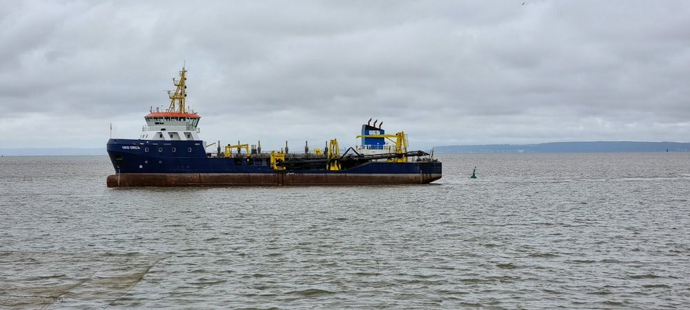 black ship on sea under white sky during daytime