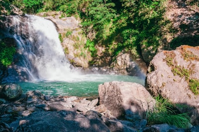 water falls on rocky shore during daytime visually stimulating google meet background