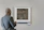 Close-up of a man admiring an art-based gift, with a serene and thoughtful expression.