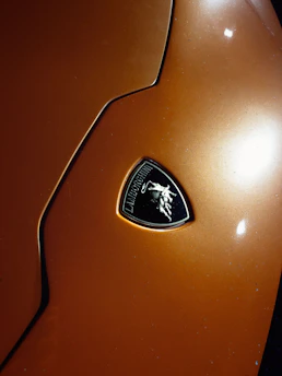 Close-up of cash being exchanged over a car hood with green and orange branding in the background.