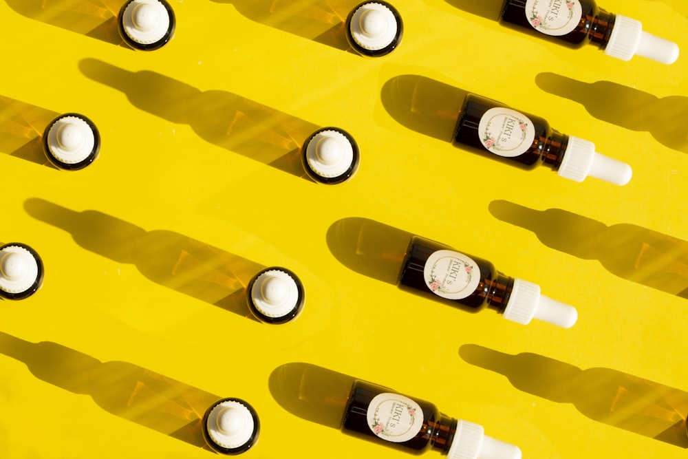 clear glass bottles on yellow plastic container