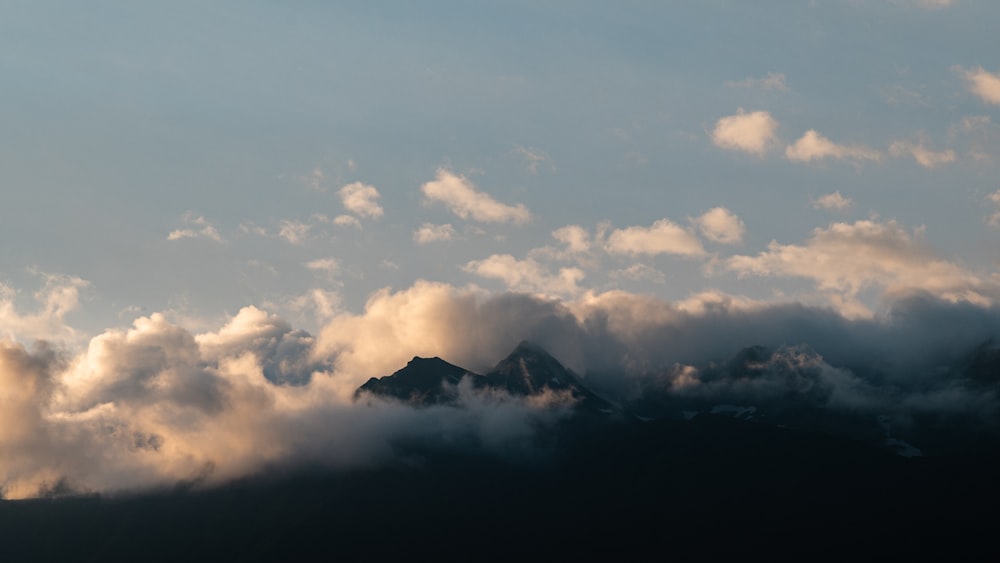 white clouds over mountain ranges