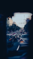 A busy urban road with cars moving during rush hour.