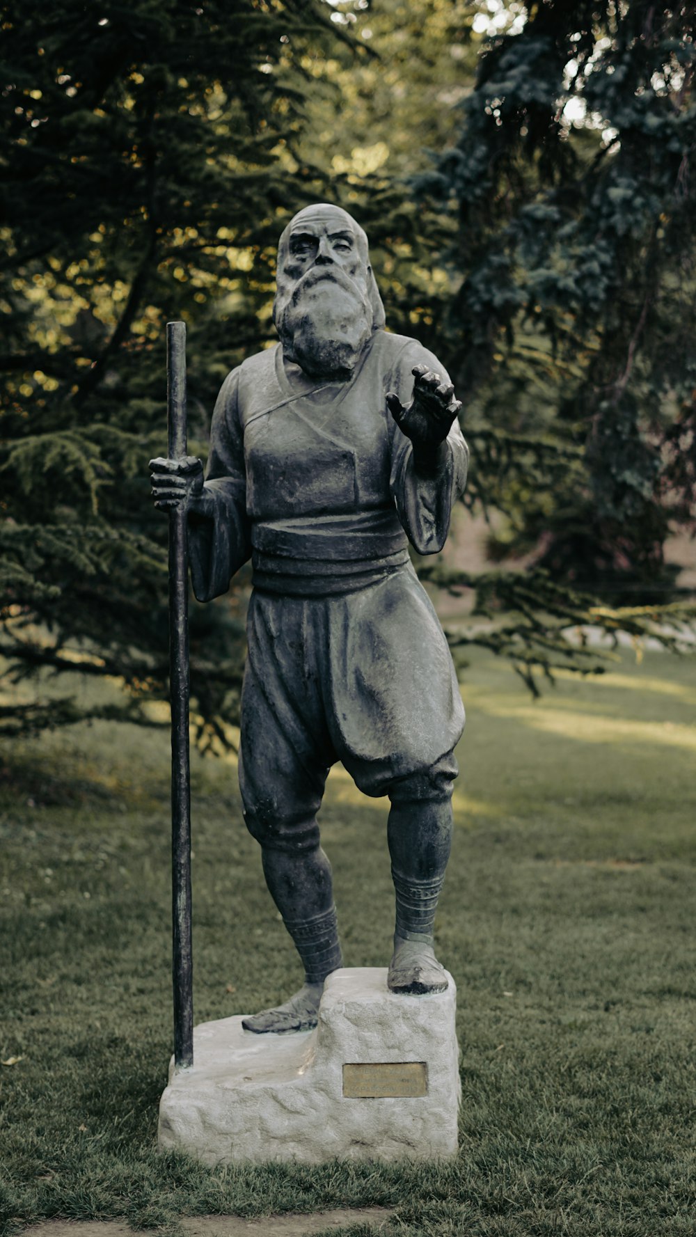 man holding black stick statue