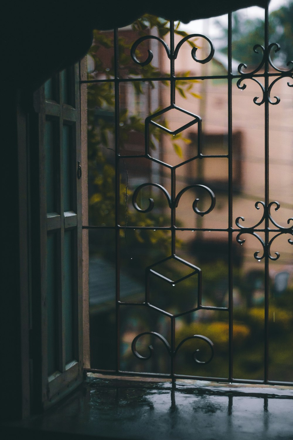 black metal window grill during daytime