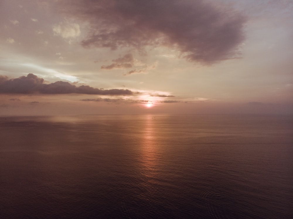 body of water during sunset