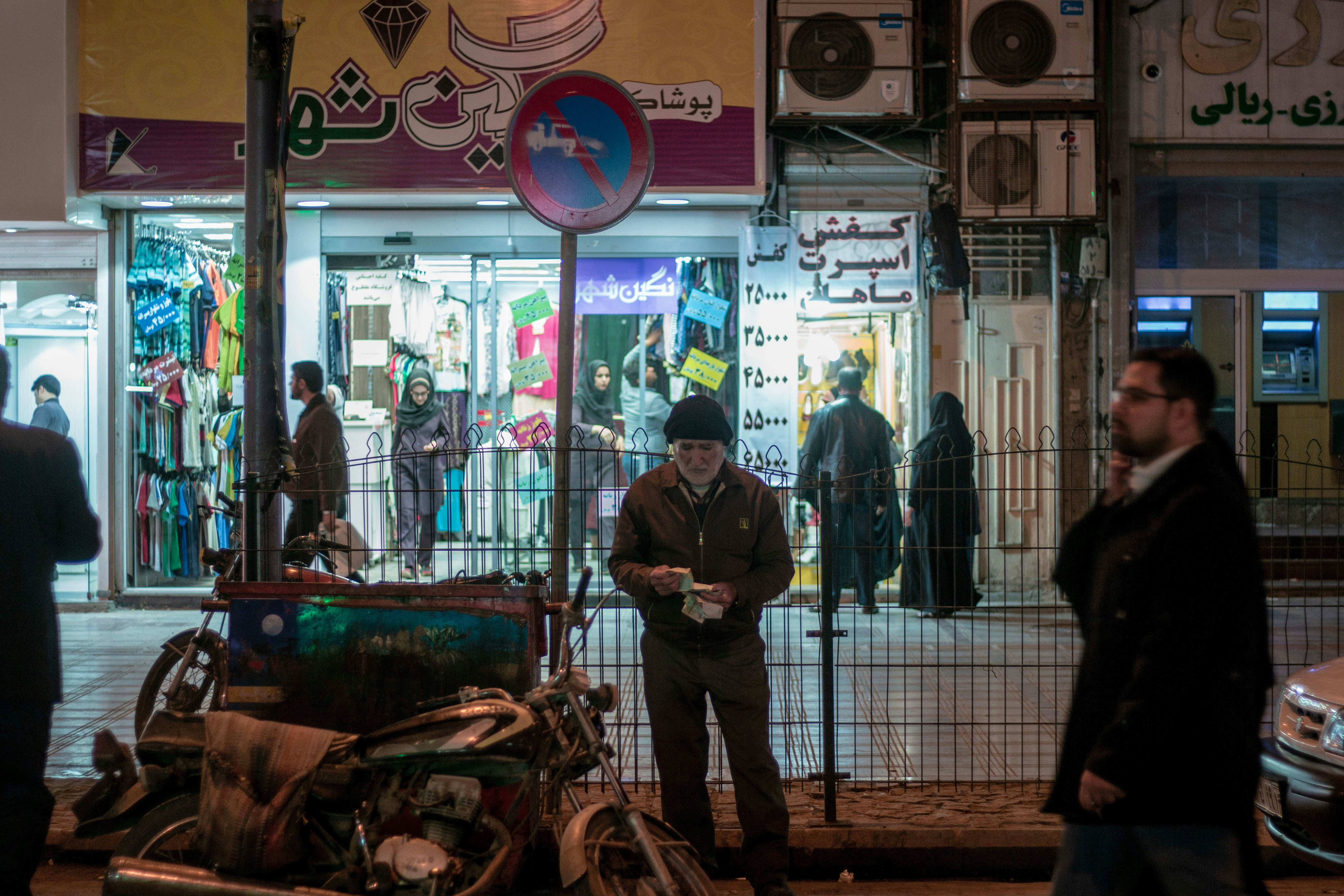 man in black jacket standing near store