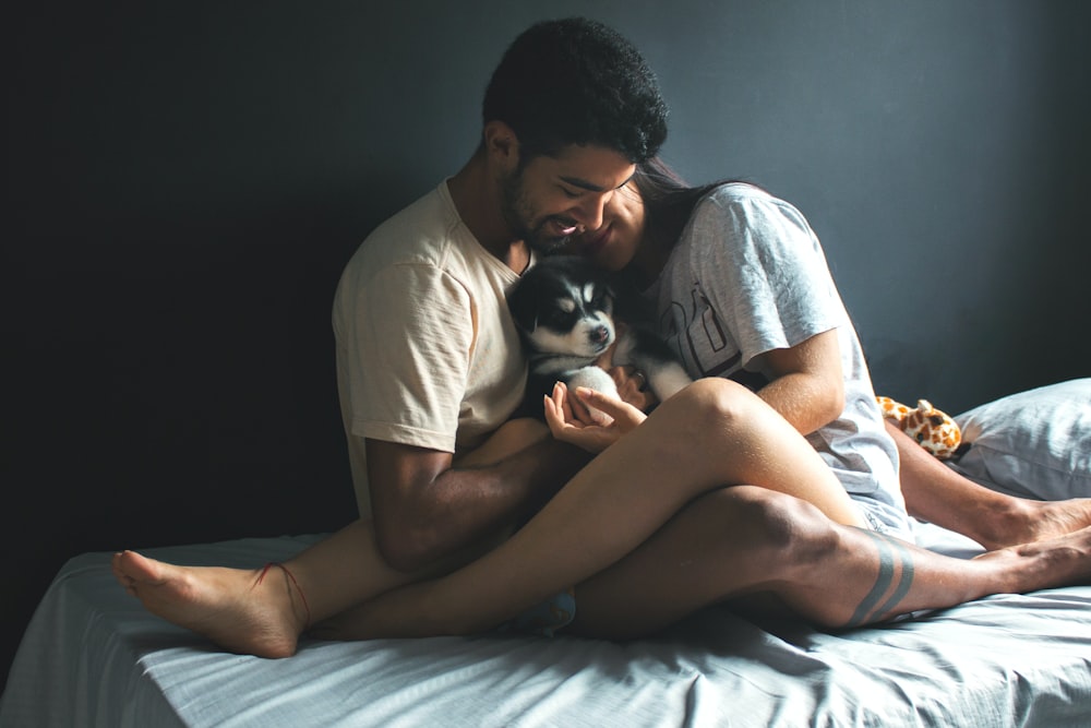 man in white t-shirt and woman in white t-shirt kissing