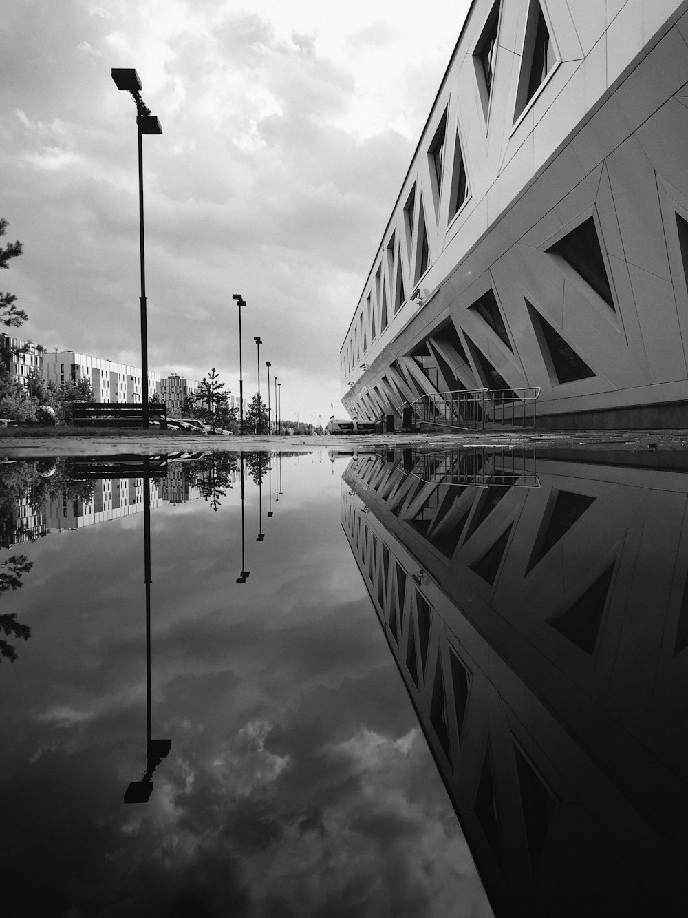 grayscale photo of building near body of water