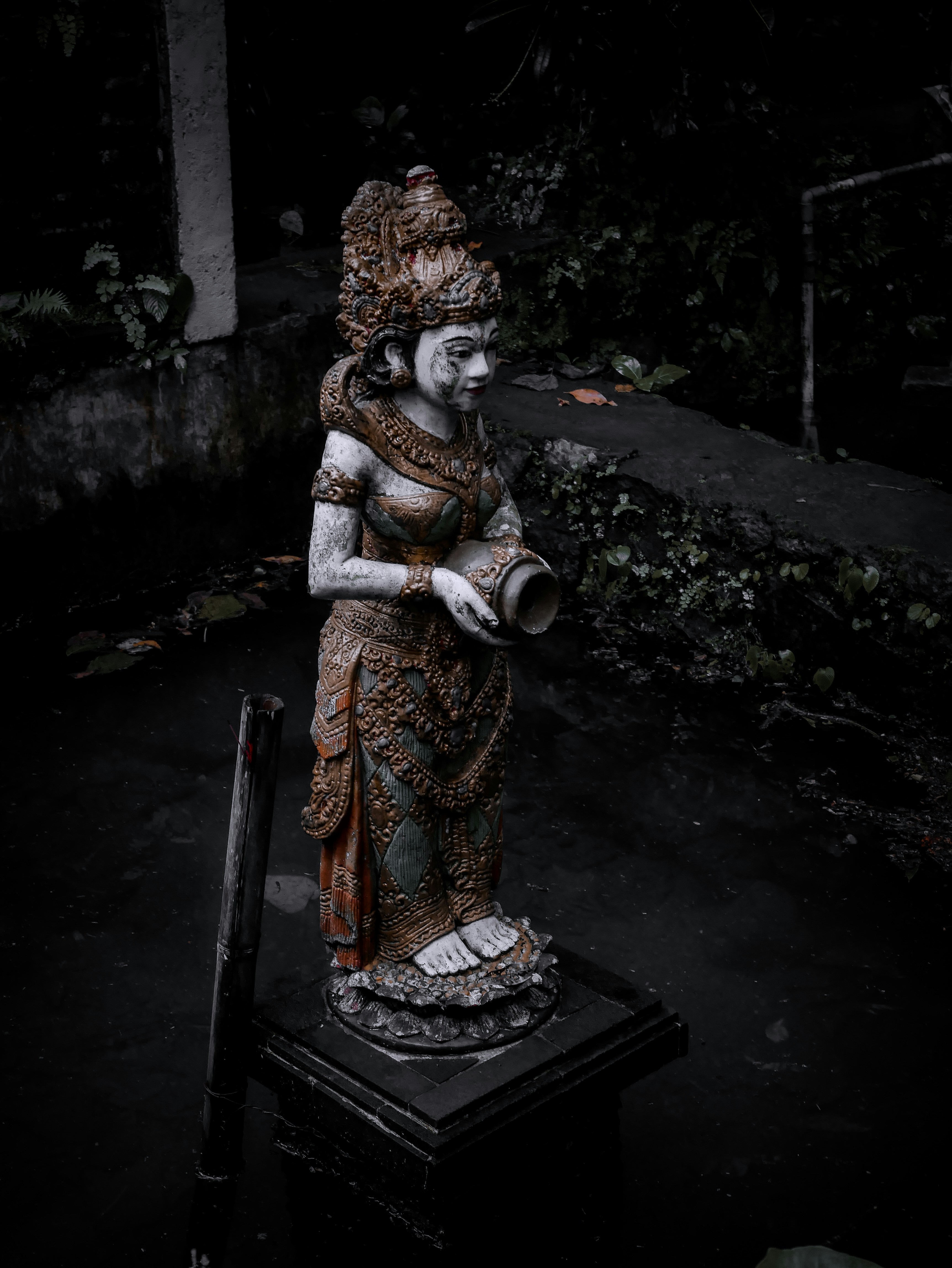 woman in brown and red dress sitting on black wooden chair