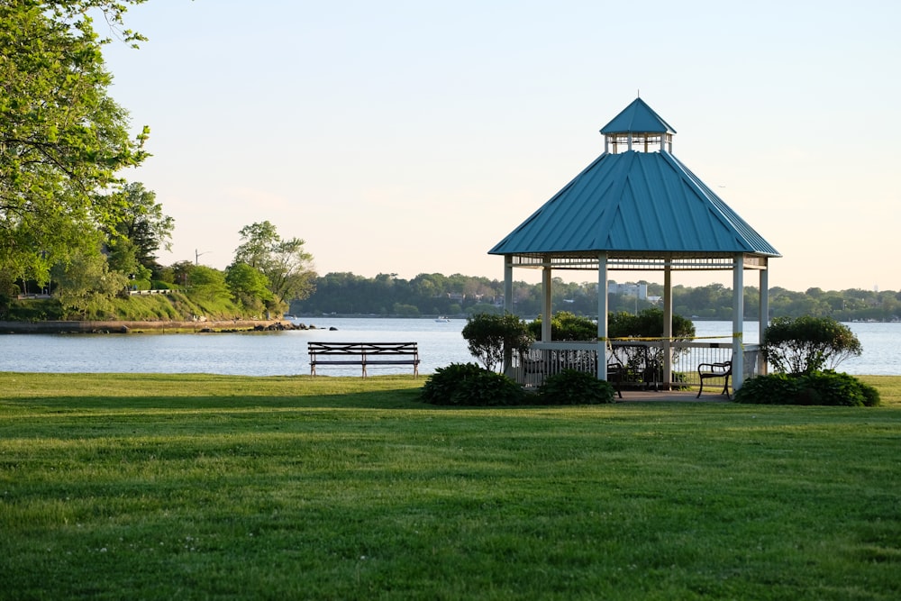 white and blue gazebo near body of water during daytime